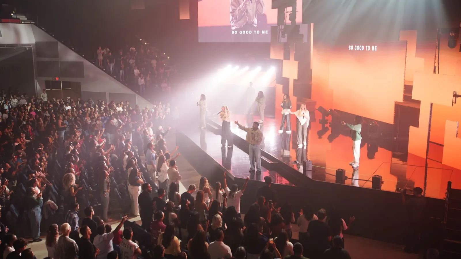 A packed worship night under stage lights